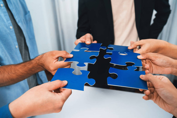 Business team joining jigsaw puzzle together symbolize group of business partnership and strong collective unity teamwork in problem solving solution for business success. Prudent - Photo, Image