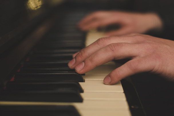 Hands playing the piano (close-up) with oldschool vintage instagram filter - 写真・画像
