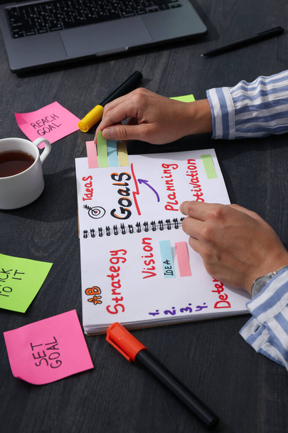 Un plan d'objectifs dans un carnet sur une table avec des papiers - Photo, image