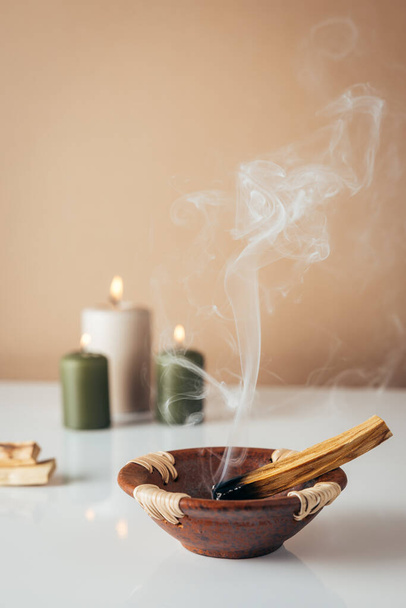 Palo santo burning stick and candles in background with copyspace - Photo, Image