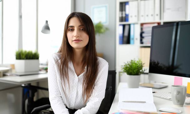 Portrait of beautiful businesswoman looking at camera with gladness. Wondeful businesslady on workplace in office. Business and art design concept. Blurred background - Foto, Bild