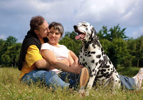 Loving couple with a Dalmatian outdoors - Photo, Image