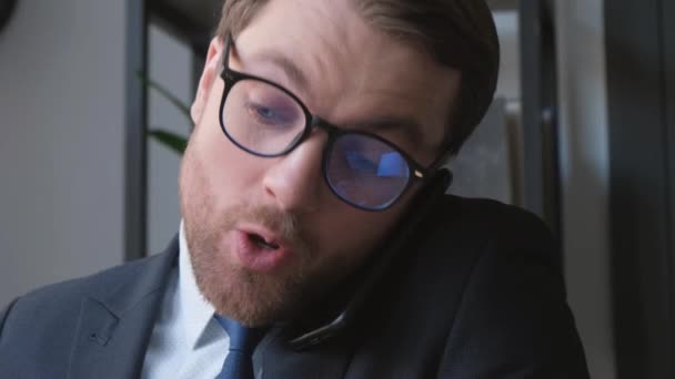 Close-up of an office manager talking on the phone at work. - Footage, Video