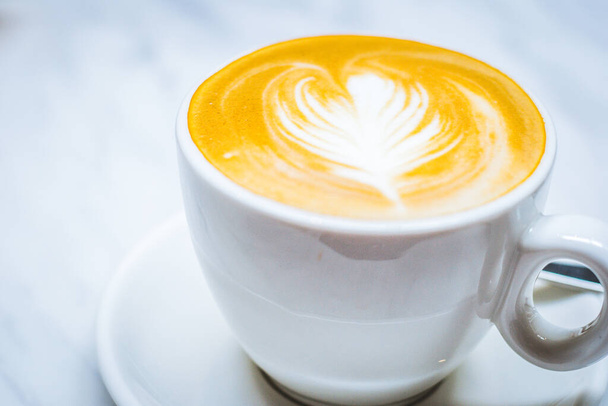 latte art s mléčnou pěnou a mlékem a espressem v bílém porcelánovém šálku - Fotografie, Obrázek