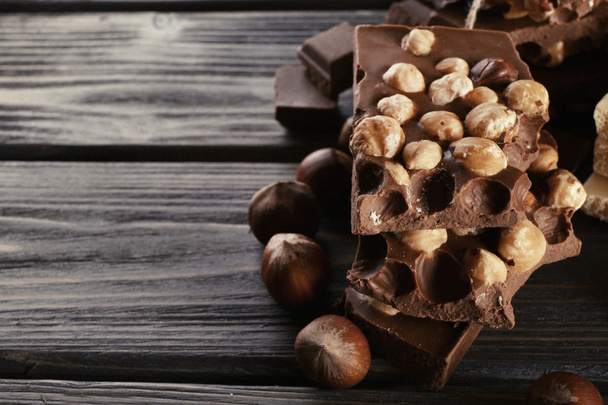 Set of chocolate with hazelnut on wooden background - Foto, afbeelding