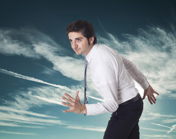 Determined businessman running in the sky - Foto, afbeelding