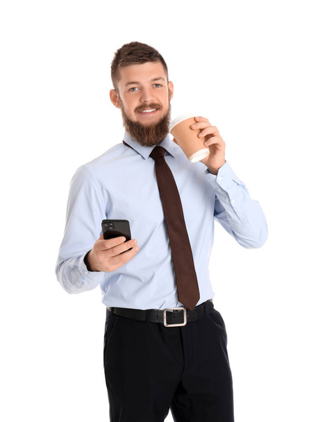 ホワイトバックに携帯電話とコーヒーのカップを持つハンサムなビジネスマン - 写真・画像