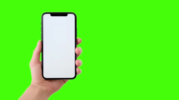 Malli tyhjän matkapuhelimen näytöt käsissä vihreällä näytöllä tausta lisäämällä halutun tekstin. - Materiaali, video