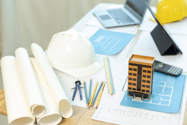 Building models and blueprints are placed on work desks in the construction engineering team offices to plan construction to achieve their goals and to simulate building models for clients to see. - Photo, Image