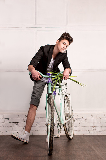 Young man on bicycle - Photo, image