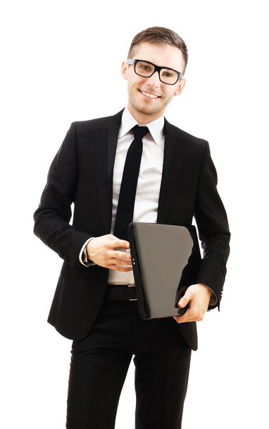Business man holding a laptop and smiling. - Foto, afbeelding