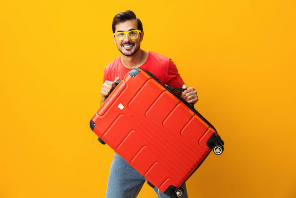 Adam hayat tarzını taklit ediyor. Tatil seyahati hipster adam sarı arka plan seyahat hafta sonu uzay gezgini mutlu bavul stüdyo seyahat valizi. - Fotoğraf, Görsel