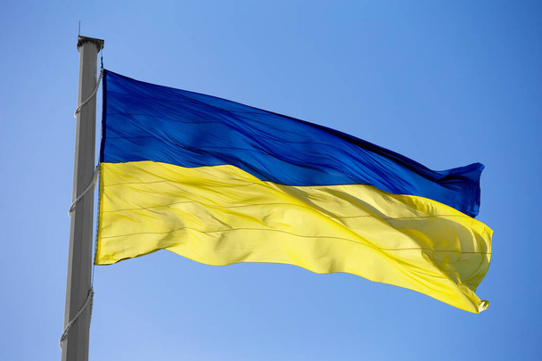 Flag of ukraine against the blue sky close-up. National pride and symbol of the country Ukraine. War in Ukraine. Yellow-blue flag. - Foto, imagen