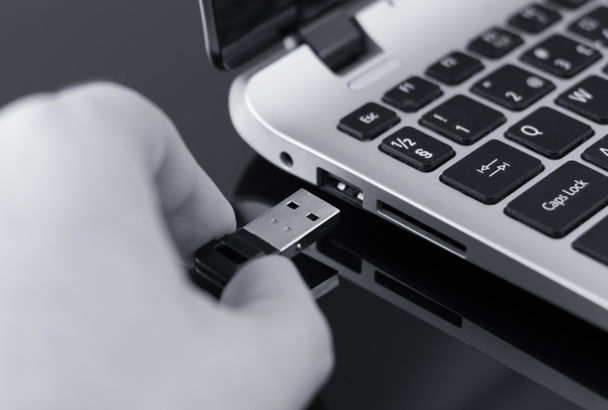 Mão plugar usb flash drive para laptop. Foto em preto e branco
. - Foto, Imagem