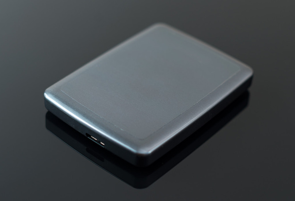 Disco duro USB externo en la mesa negra
. - Foto, Imagen