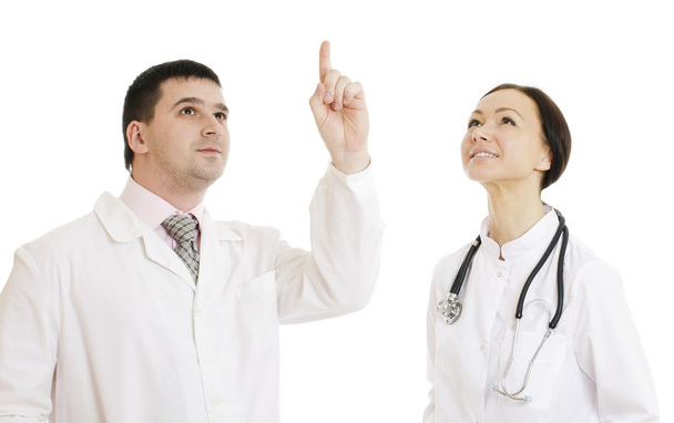 Two doctors male and female  pointing finger upwards - 写真・画像