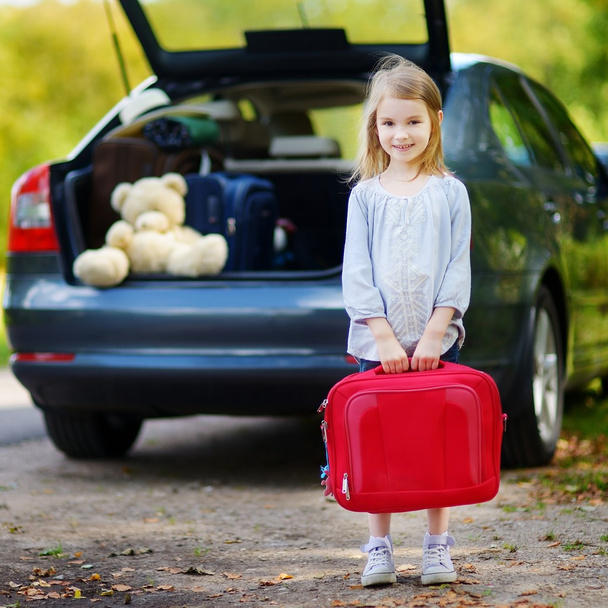 Adorable little girl with suitcase - Фото, зображення