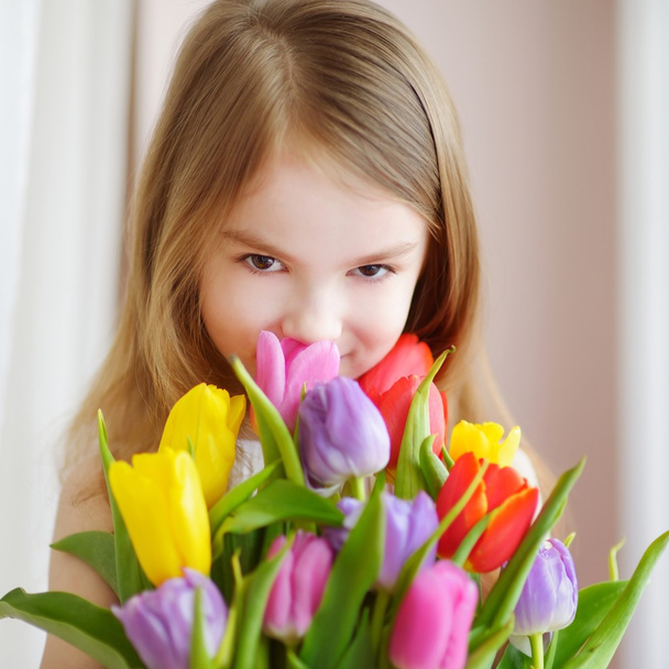 little girl with colorful tulips - Zdjęcie, obraz
