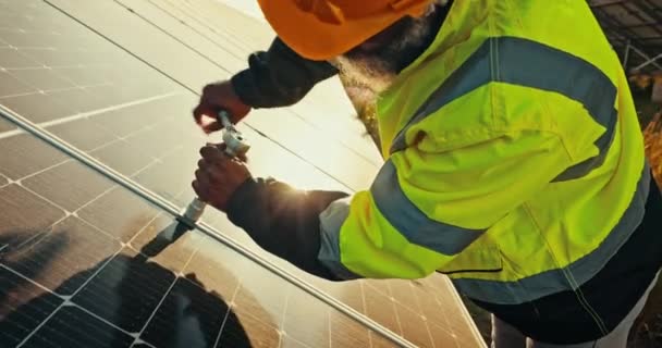 Solar panel, maintenance and construction worker with renewable energy and electricity project. Male contractor, sustainability and roof with eco friendly repair on a rooftop with installation. - Footage, Video