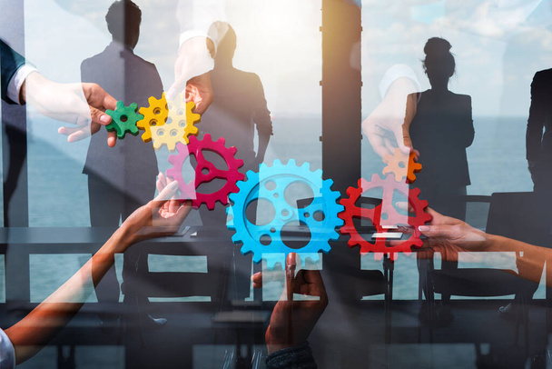 Business people connect pieces of gears. Partnership and integration concept - Photo, Image