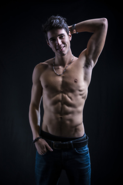 Handsome muscular shirtless young man standing - Photo, image