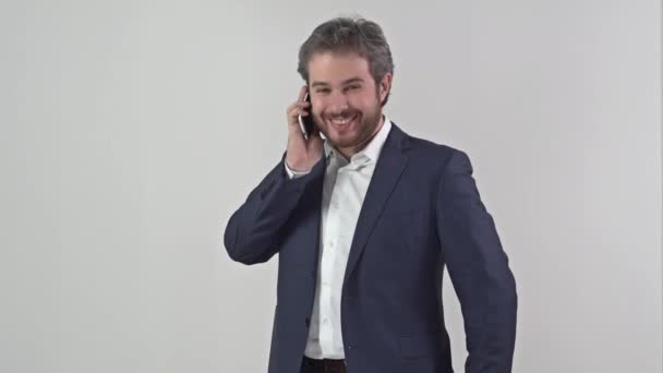 Man in suit talking on a mobile phone full video - Video