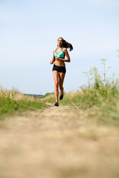 Woman Runner. Fitness Girl Running outdoors  - Fotografie, Obrázek