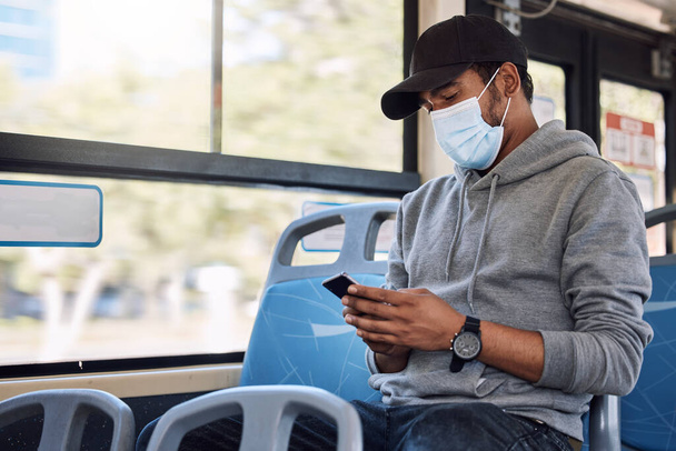 Mask, phone and man travel in bus, journey and typing email on mobile app technology. Smartphone, public transport and person on internet, social media or networking on commute to city with covid ppe. - Photo, Image
