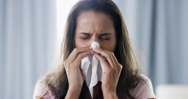 Woman, tissue and blowing nose in home, sick and cleaning for health, wellness and mucus in bedroom. Girl, paper and frustrated with allergies, virus or sneeze in morning, wake up and flu bacteria. - Footage, Video