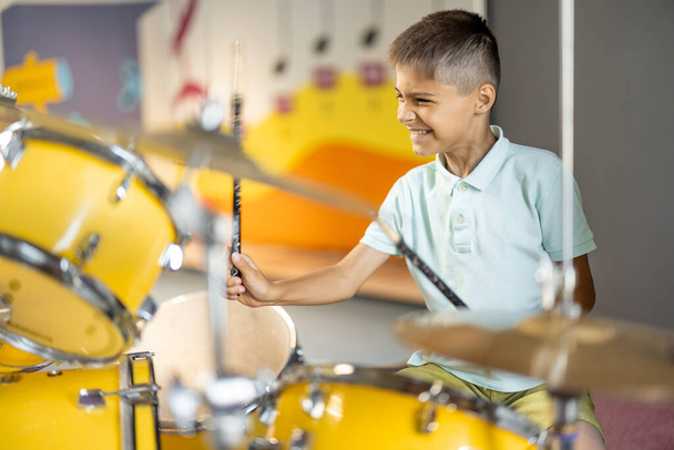 Little boy playing on a real drums, having fun while visiting a science museum - Photo, Image