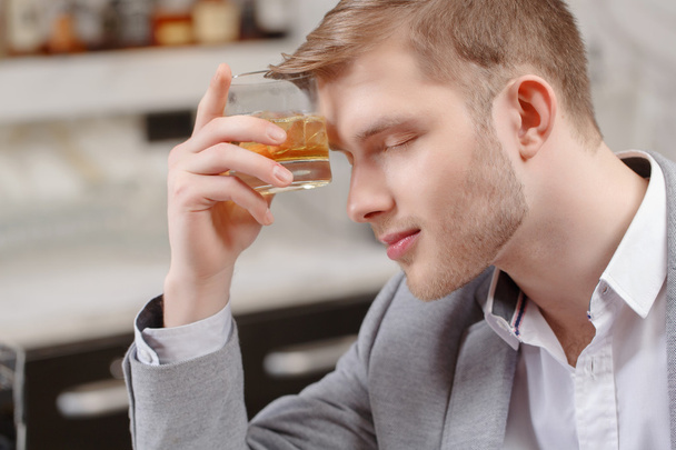 Man with a cocktail in the bar - Photo, image