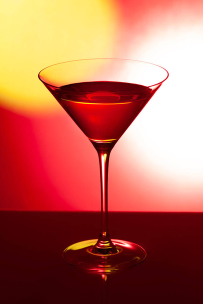 Glass martini glass on a red background - Photo, Image