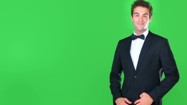 Man, suit and thinking on green screen for formal presentation, advertising space and luxury fashion or event. Professional person or model in tuxedo with thumbs up, yes or like on studio background. - Footage, Video