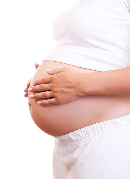 Έγκυος γυναίκα αγγίζει την κοιλιά της με τα χέρια - Φωτογραφία, εικόνα