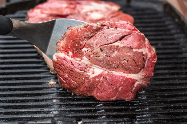 Beef steaks on grill or BBQ with spatula - Photo, Image