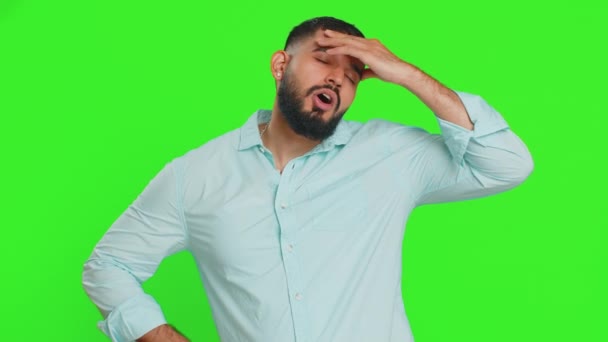 Displeased exhausted Indian man guy rubbing temples to cure headache problem, suffering from tension, migraine, stress, grimacing in pain, high blood pressure isolated alone on chroma key background - Footage, Video