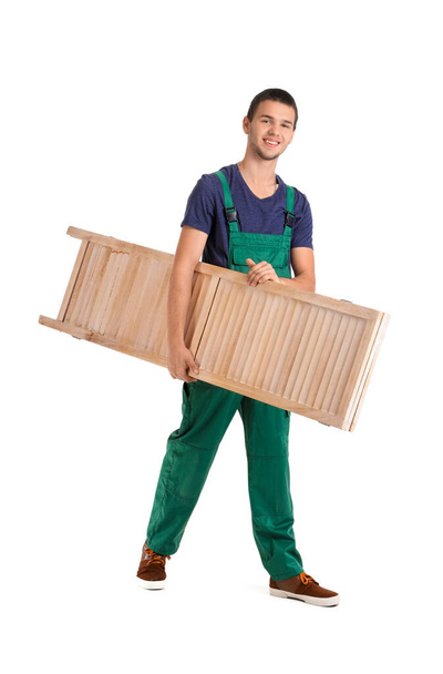 Young loader carrying folding screen on white background - Photo, Image