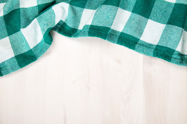 green folded tablecloth over bleached wooden table - Photo, Image