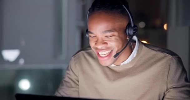 Black man, laptop and consulting in call center at night for customer service, advisory and questions. Face, happy salesman and working late on pc in CRM agency for telecom support, FAQ and contact. - Footage, Video