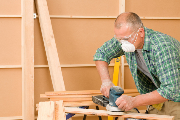 Handyman sanding wooden board diy home renovation - Foto, imagen