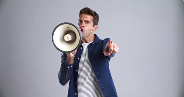 Man, megaphone and announcement, speech and pointing at you to join us in protest, call to action or choice. Portrait, screaming and person on speaker, mockup and broadcast news on a grey background. - Footage, Video