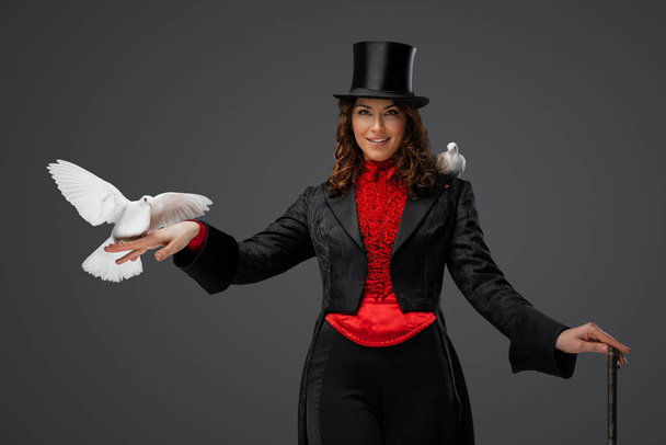 Mystický výkon, ženské kouzelnice a bílé holubice na šedém pozadí - Fotografie, Obrázek