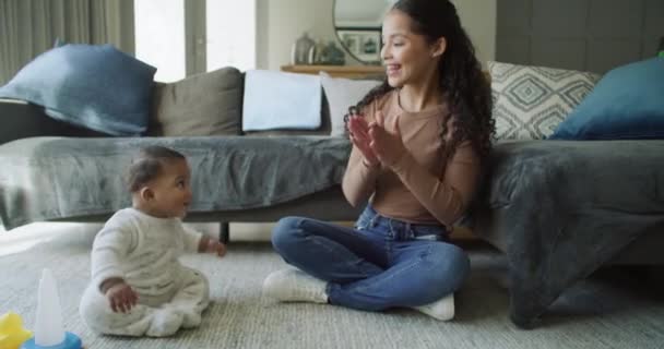 .Clapping hands, mother and baby playing at home for bonding, learning and quality time. Woman with excited child for love, care and singing for growth and development on floor in a family lounge - Footage, Video