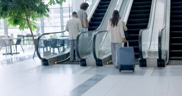 Airport, back and corporate people on an escalator with luggage for international travel or transport. Business, global and professional employees in a terminal, leaving for a trip or journey. - Footage, Video
