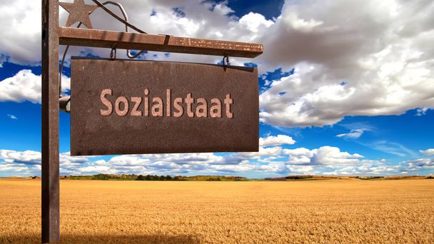 Una imagen con una señal en alemán apuntando en la dirección del estado del bienestar. - Foto, imagen