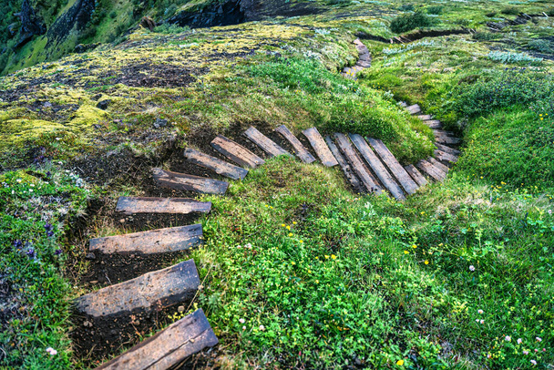 Felett ívelt fából készült lépcső nyomvonal dombon között a hegyvidéki nyáron Izlandon - Fotó, kép