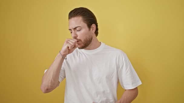 Young hispanic man coughing over isolated yellow background - Footage, Video