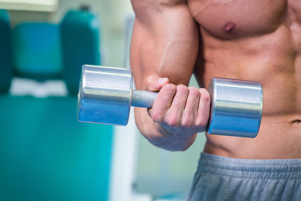Muscular man working out with dumbbells - Foto, Imagen