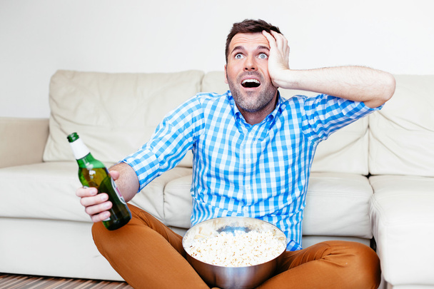 Sports fan watching game on tv - Photo, Image