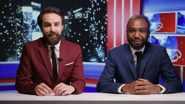 Diverse reporters host night talk show on international television network, creating reportage on breaking news with latest topics. Journalists team presenting entertainment and media segment. - Photo, Image